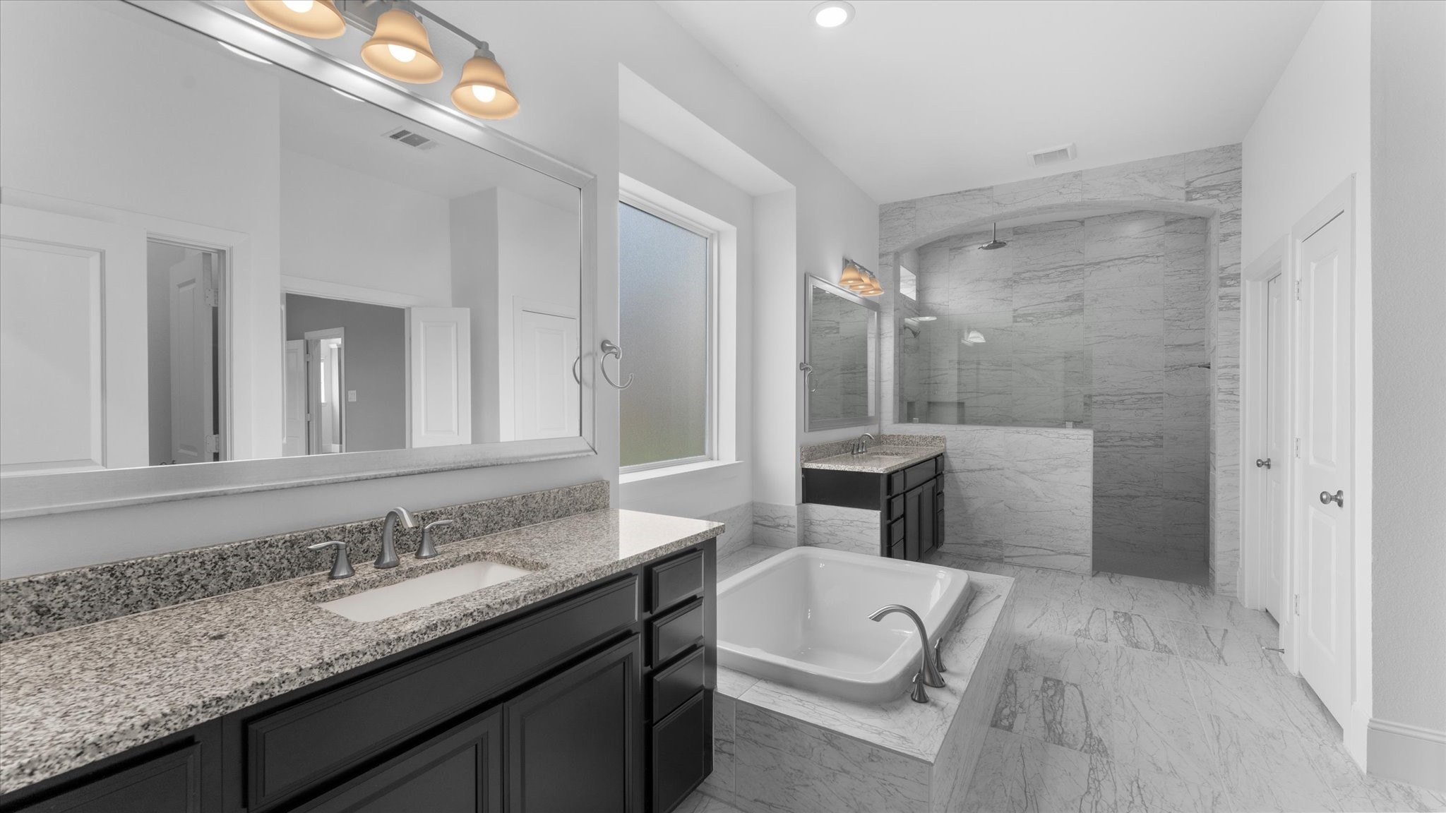32001 Birch Briar Court Spring, TX 77386 - Photo 25 of 48 Spa-inspired ensuite featuring dual sinks, extensive counter space, a walk-in shower, soaking tub, and premium finishes.