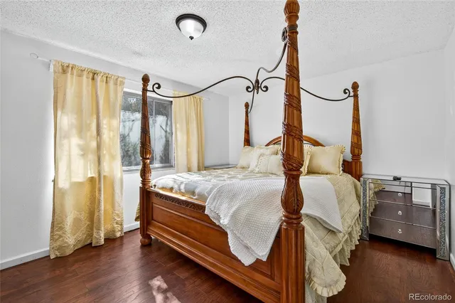 a bedroom with a bed window and a mirror