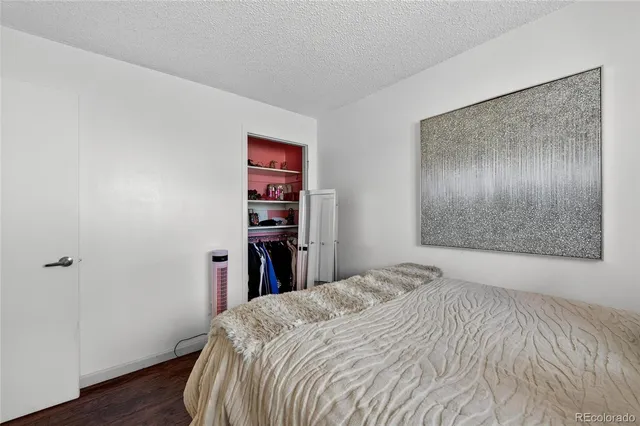 a bedroom with a bed and a wooden floor