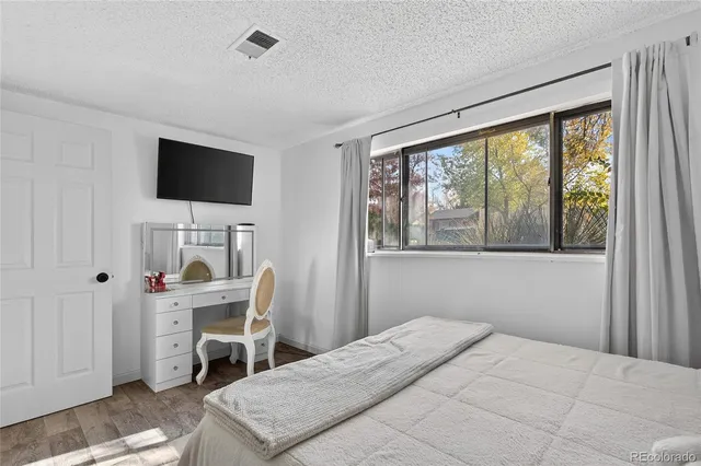 a bedroom with a bed and a television