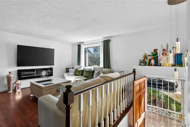 a bedroom with furniture and a flat screen tv
