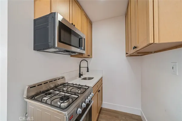 a kitchen with a stove and a microwave