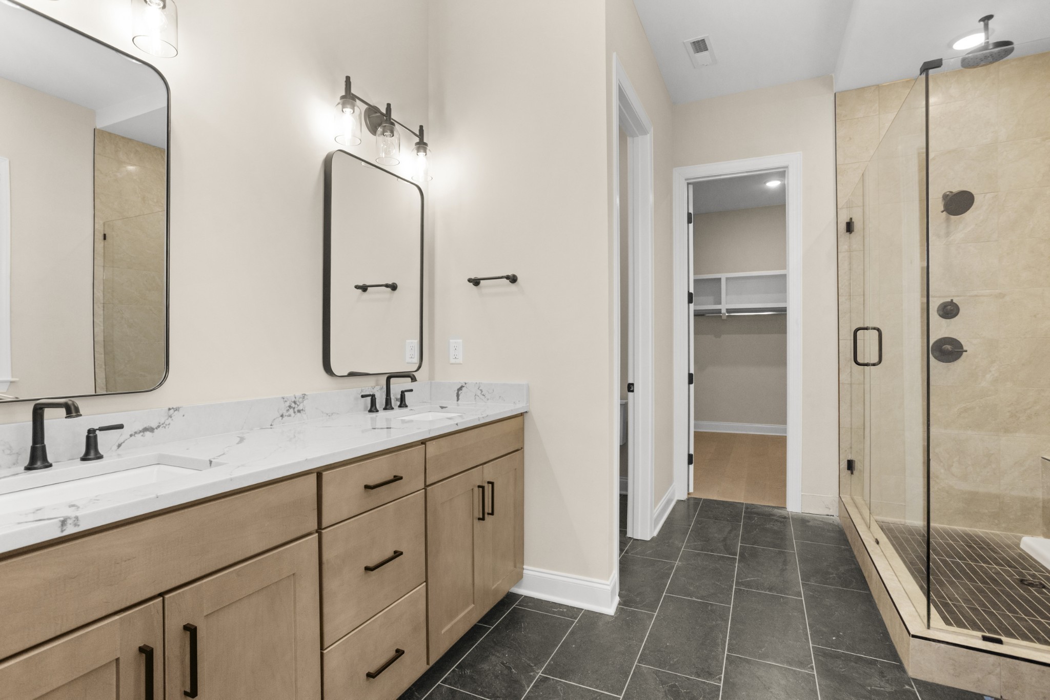 1939 Harmony Road Spring Hill, TN 37174 - Photo 22 of 50 a bathroom with a double vanity sink mirror and double