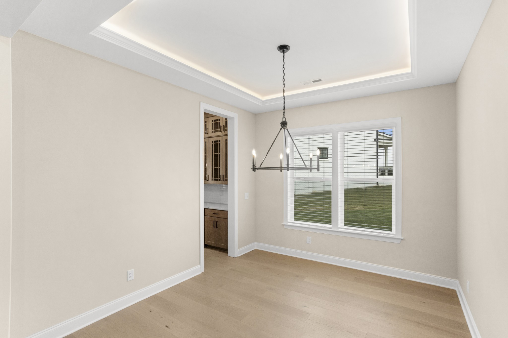 1939 Harmony Road Spring Hill, TN 37174 - Photo 5 of 50 an empty room with wooden floor chandelier and windows