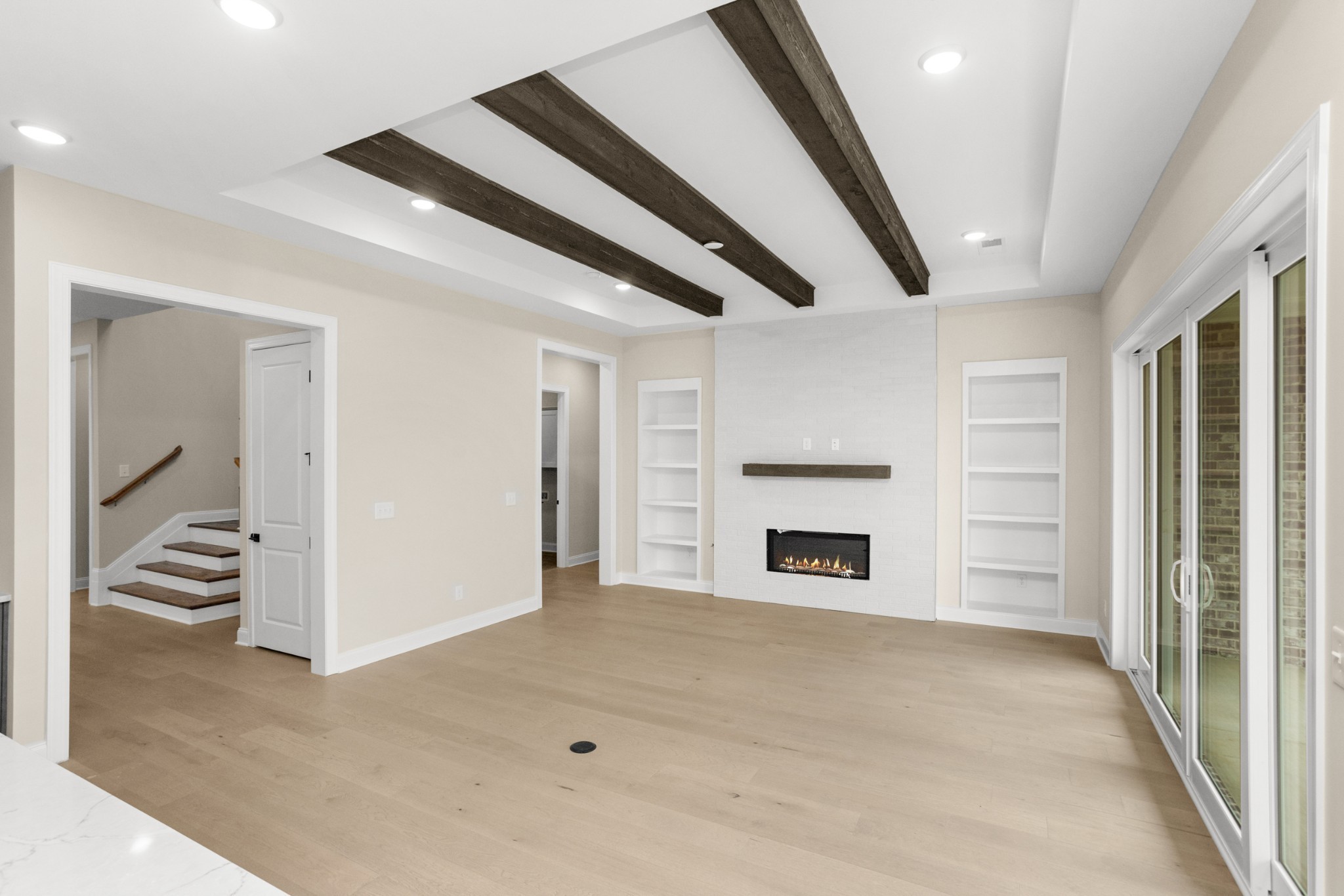 1939 Harmony Road Spring Hill, TN 37174 - Photo 9 of 50 wooden floor in an empty room with a fireplace