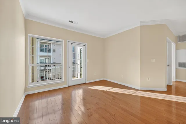 a view of an empty room with glass door