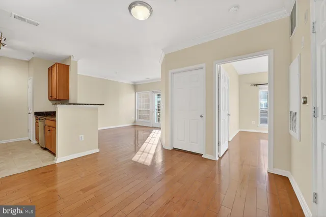 a view of a kitchen with wooden floor and a refrigerator