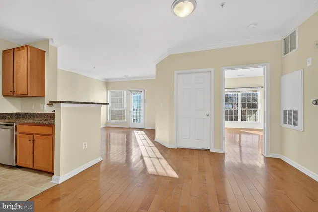 a view of a kitchen with wooden floor and a sink