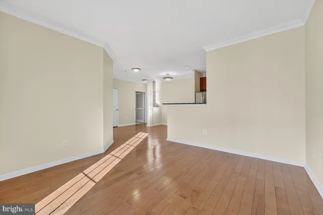 a view of empty room with wooden floor