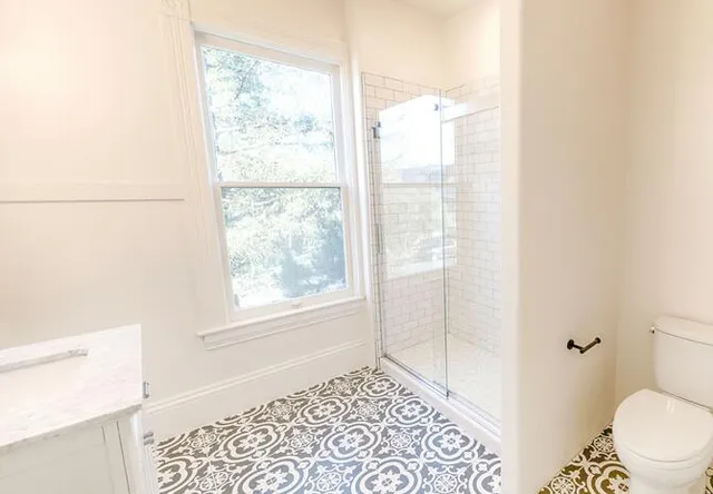 a bathroom with a window and a shower