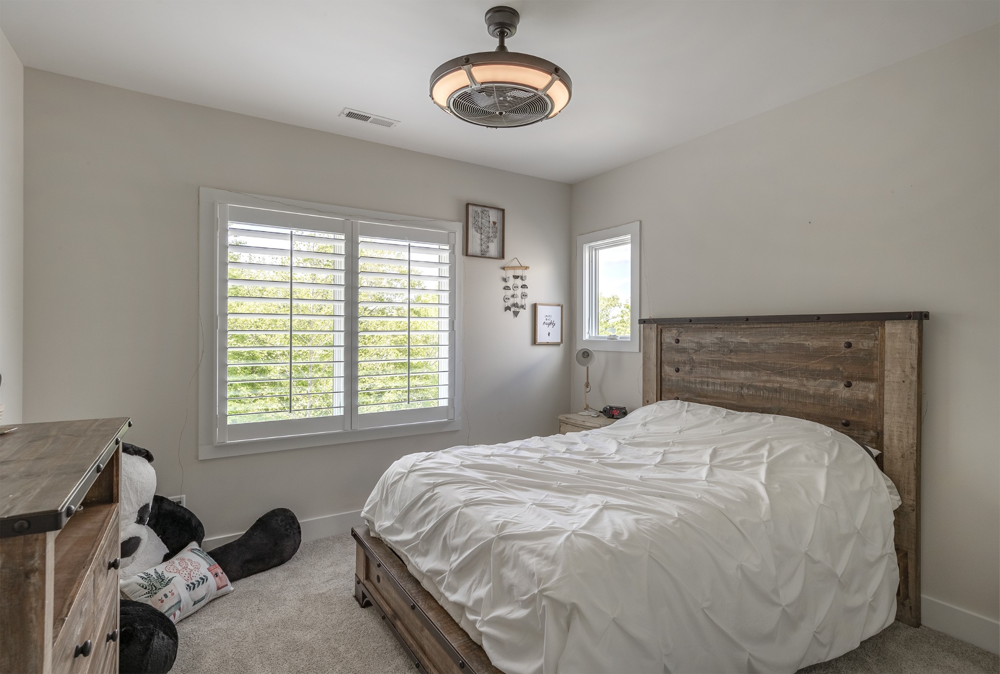 5304 Old Harding Road Franklin, TN 37064 - Photo 14 of 29 a large bed sitting in a bedroom next to a window and a chandelier