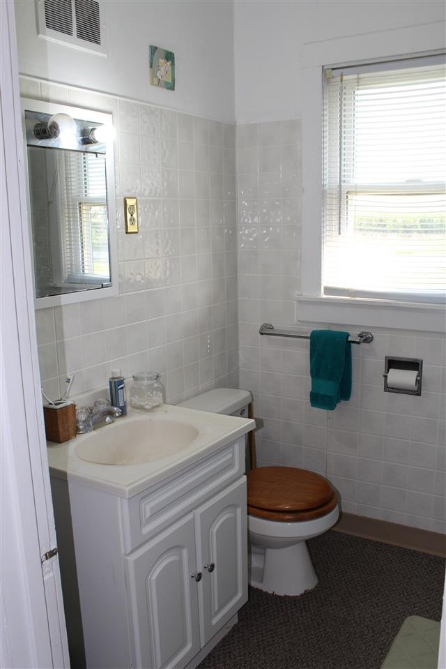 7491 Freeport Road Rockton, IL 61072 - Photo 8 of 13 a bathroom with a toilet sink and mirror