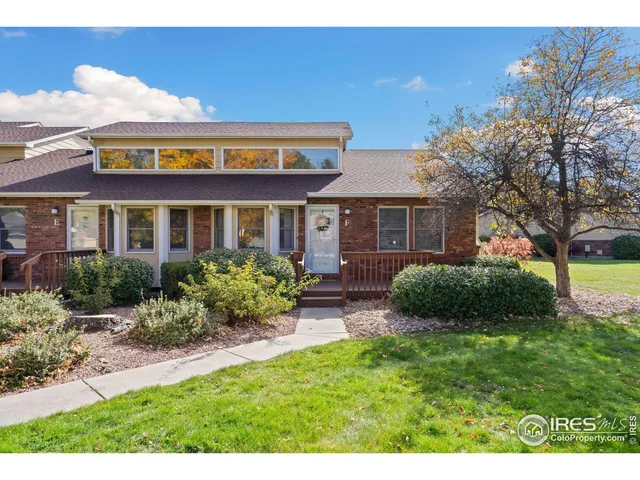 a view of a house with a yard and potted plants