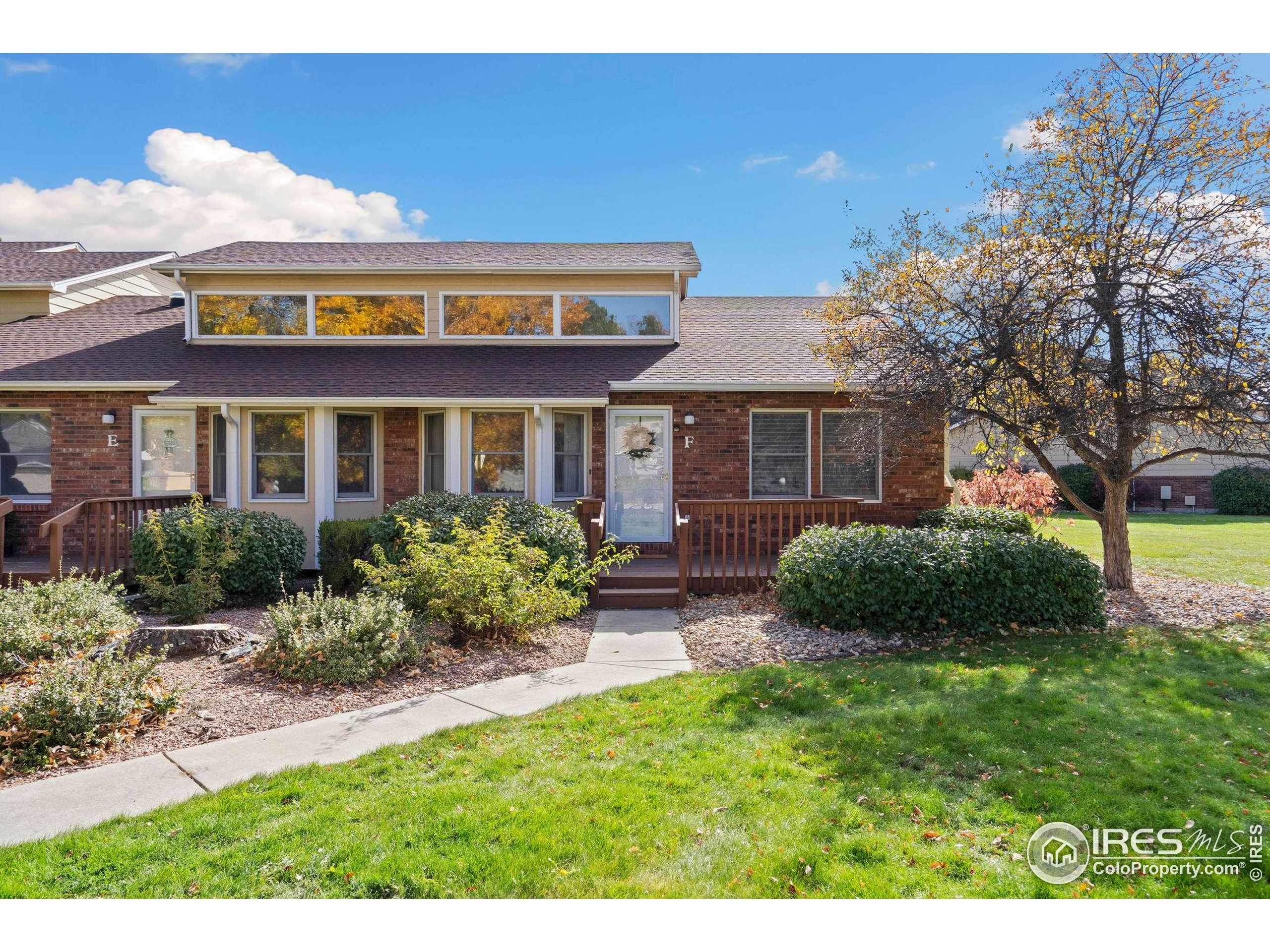 3344 Hickok Drive, Unit F Fort Collins, CO 80526 - Photo 1 of 24 a view of a house with a yard and potted plants