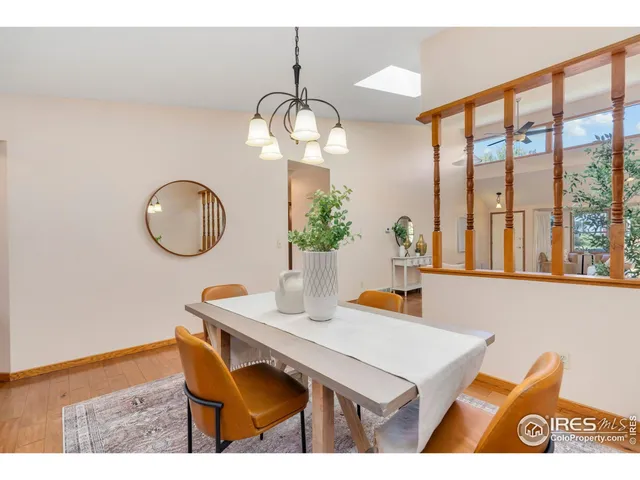 a view of a dining room with furniture a chandelier and wooden floor
