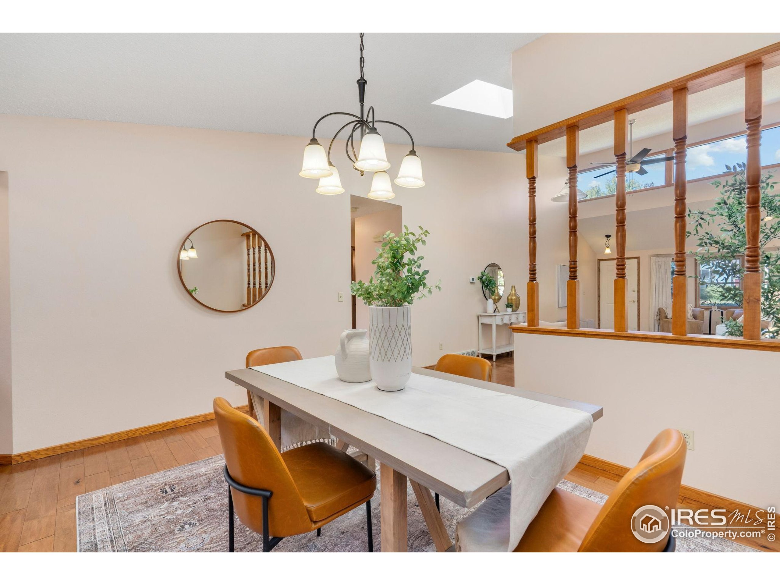 3344 Hickok Drive, Unit F Fort Collins, CO 80526 - Photo 11 of 24 a view of a dining room with furniture a chandelier and wooden floor