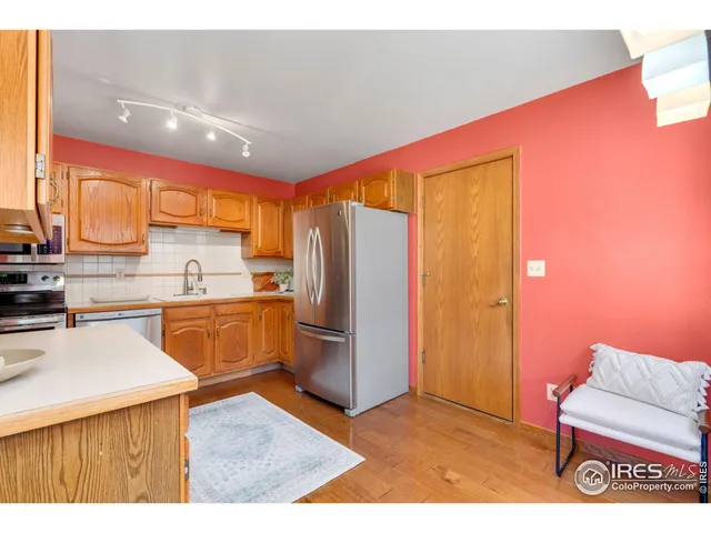 a kitchen with stainless steel appliances kitchen island granite countertop a refrigerator and a stove top oven