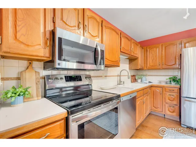 a kitchen with stainless steel appliances a stove a sink and a microwave