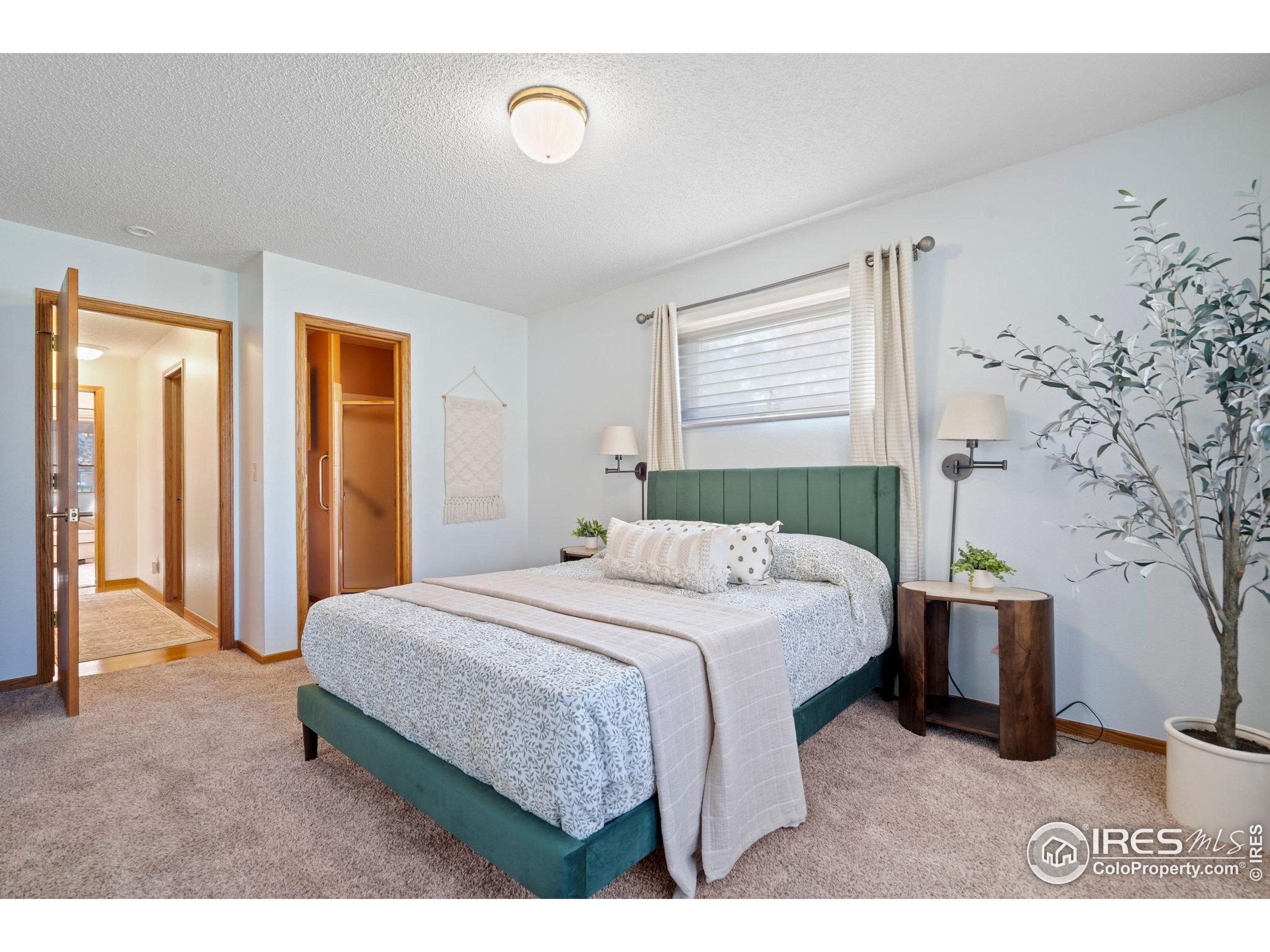 3344 Hickok Drive, Unit F Fort Collins, CO 80526 - Photo 18 of 24 a bedroom with a bed and a view of bathroom