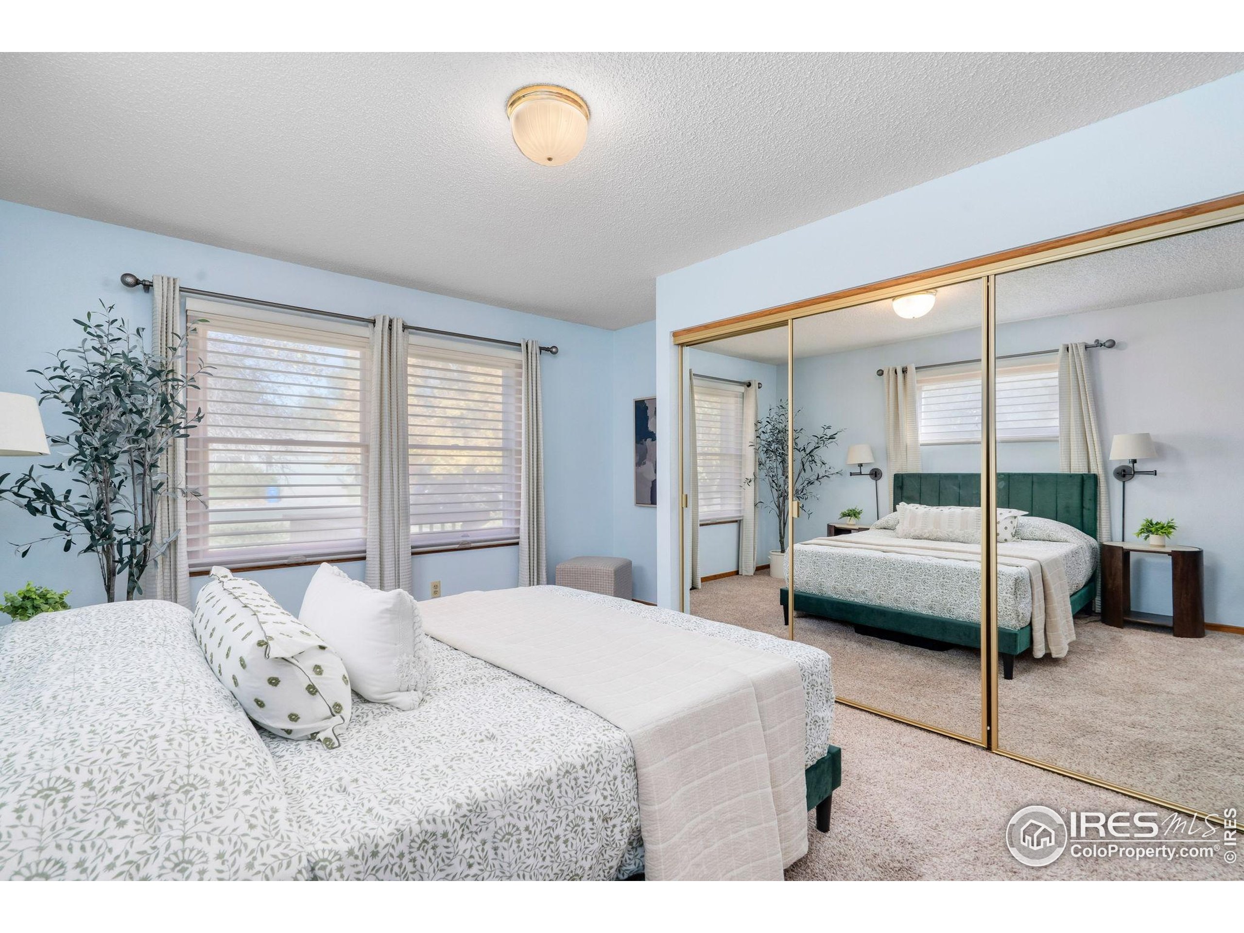 3344 Hickok Drive, Unit F Fort Collins, CO 80526 - Photo 20 of 24 a bedroom with a large bed and a large window