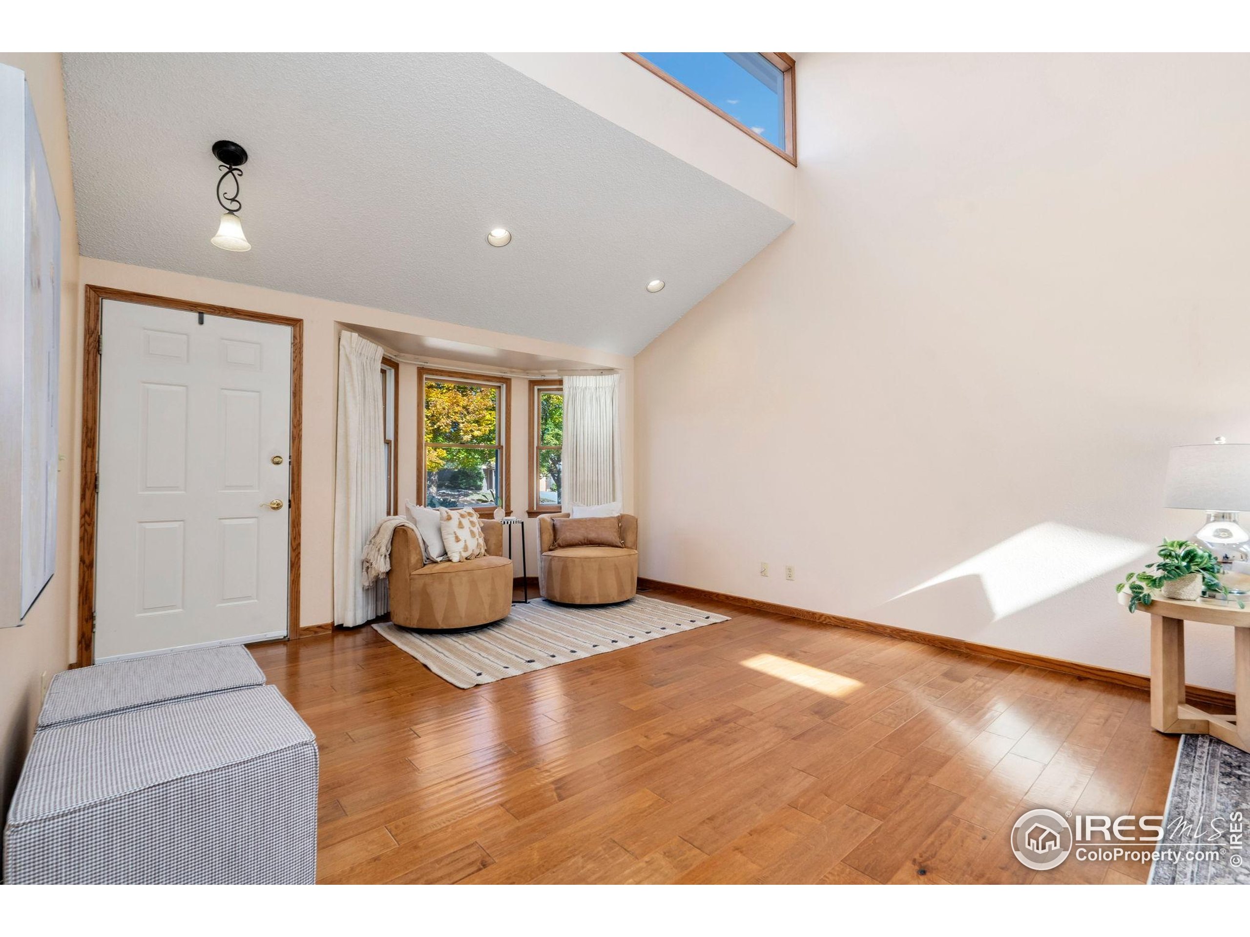 3344 Hickok Drive, Unit F Fort Collins, CO 80526 - Photo 2 of 24 a living room with furniture and a large window