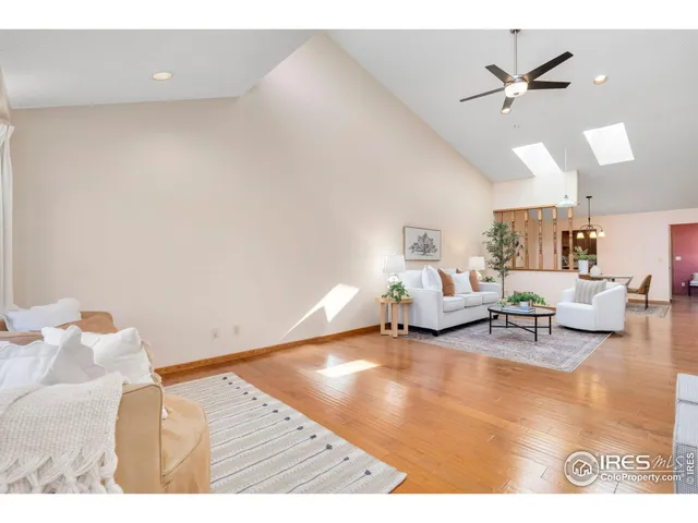 a living room with furniture and a ceiling fan