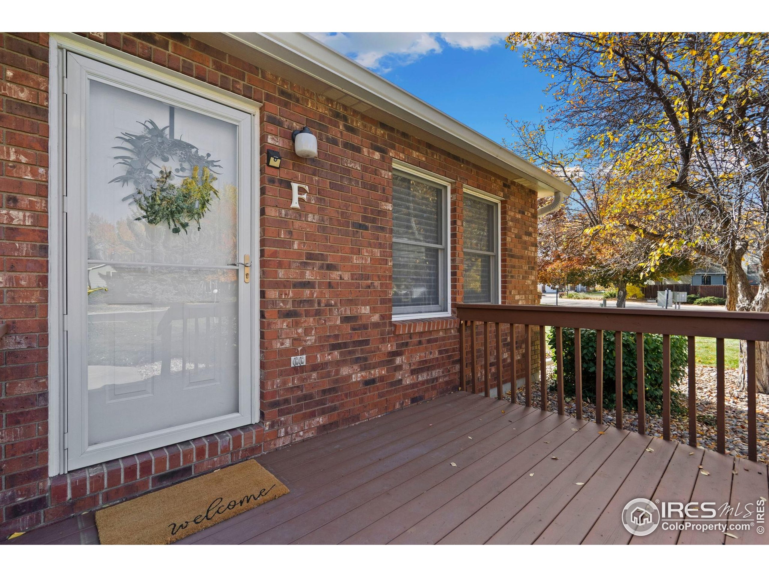 3344 Hickok Drive, Unit F Fort Collins, CO 80526 - Photo 4 of 24 a view of balcony with wooden floor and bench