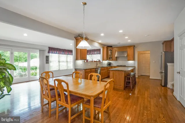 a dining room with furniture and wooden floor