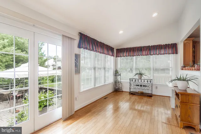 a view of a workspace with furniture and wooden floor