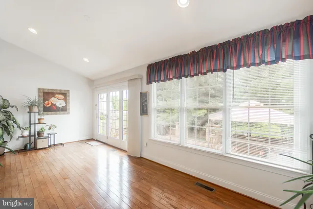 a bedroom with a bed and a flat tv screen on a dresser