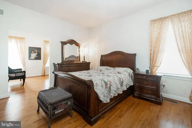 a spacious bathroom with a granite countertop sink and a mirror