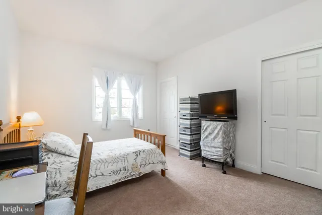 a view of walk in closet with clothes