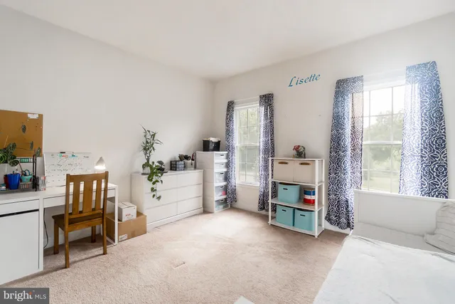 an aerial view of a house with a yard and outdoor seating