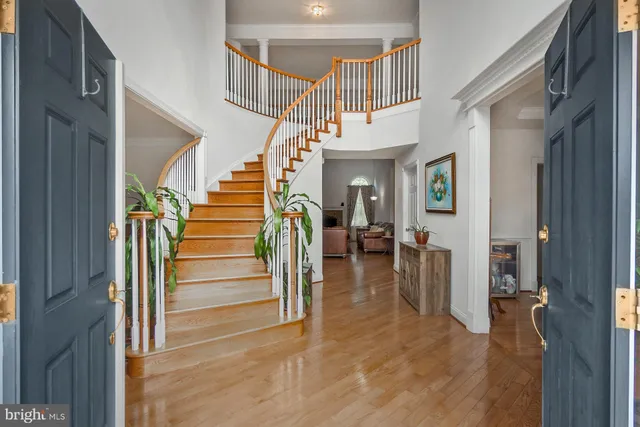 a view of entryway and hall with wooden floor