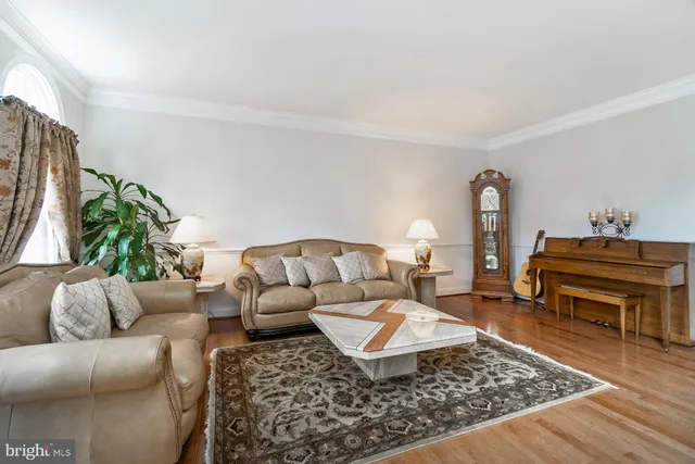 a living room with furniture and a piano