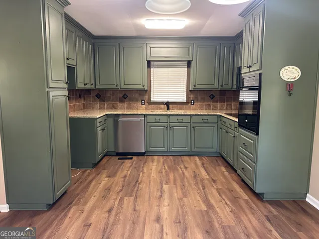 a kitchen with a sink and wooden cabinets