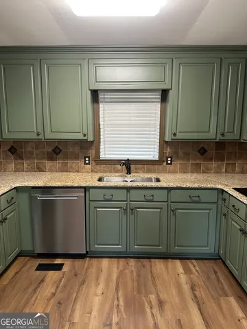 a kitchen with a sink cabinets and stainless steel appliances