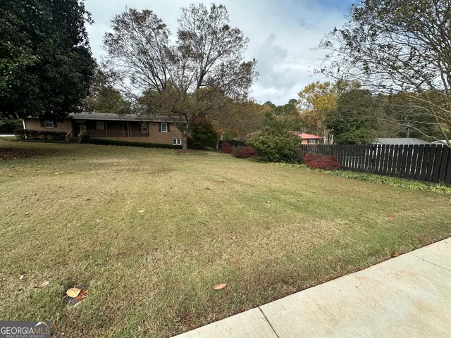 a front view of a building with large trees