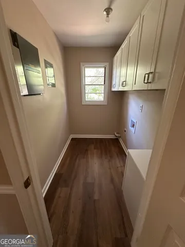a view of storage and utility room with wooden floor