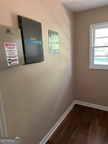 a view of empty room with wooden floor