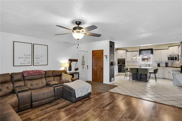 a spacious bedroom with a bed a couch and a chandelier