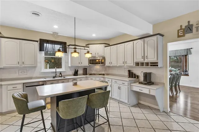 a kitchen with appliances cabinets and furniture