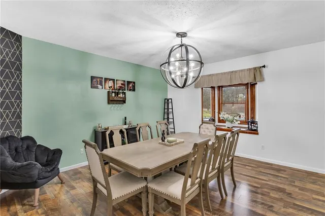 a view of a dining room with furniture wooden floor and chandelier