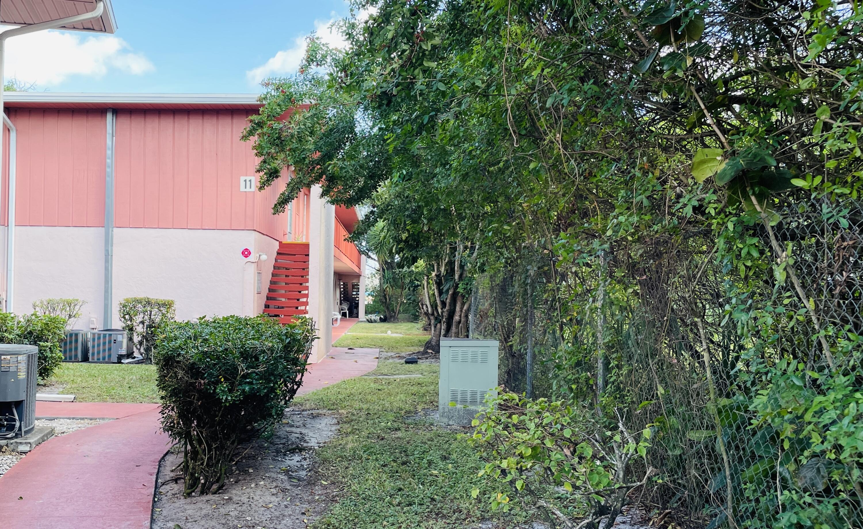 11 Golfs Edge, Unit E West Palm Beach, FL 33417 - Photo 1 of 14 a view of a back yard of the house