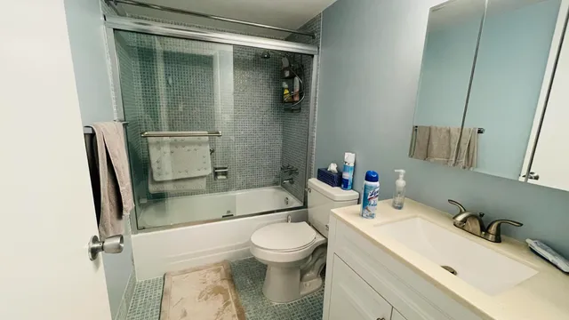 a bathroom with a sink toilet and shower