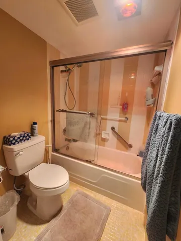 a bathroom with a toilet and a shower