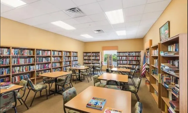 a living room with lots of furniture and a book shelf