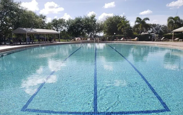 a view of a house with backyard porch and sitting area