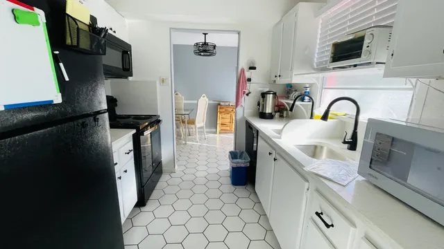 a kitchen with stainless steel appliances granite countertop a refrigerator a stove top oven a sink and dishwasher