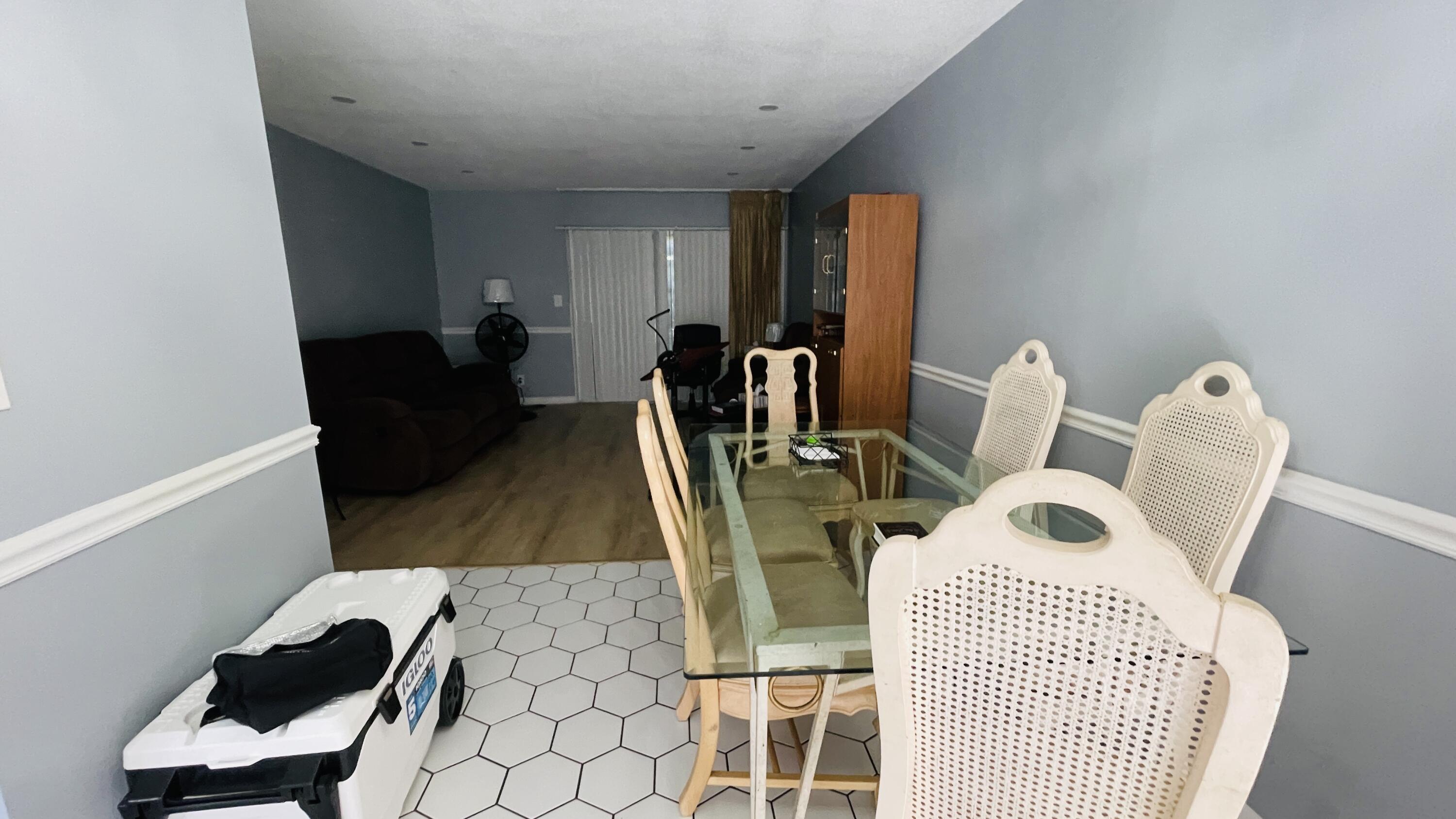 11 Golfs Edge, Unit E West Palm Beach, FL 33417 - Photo 6 of 14 a living room with furniture a flat screen tv and rug